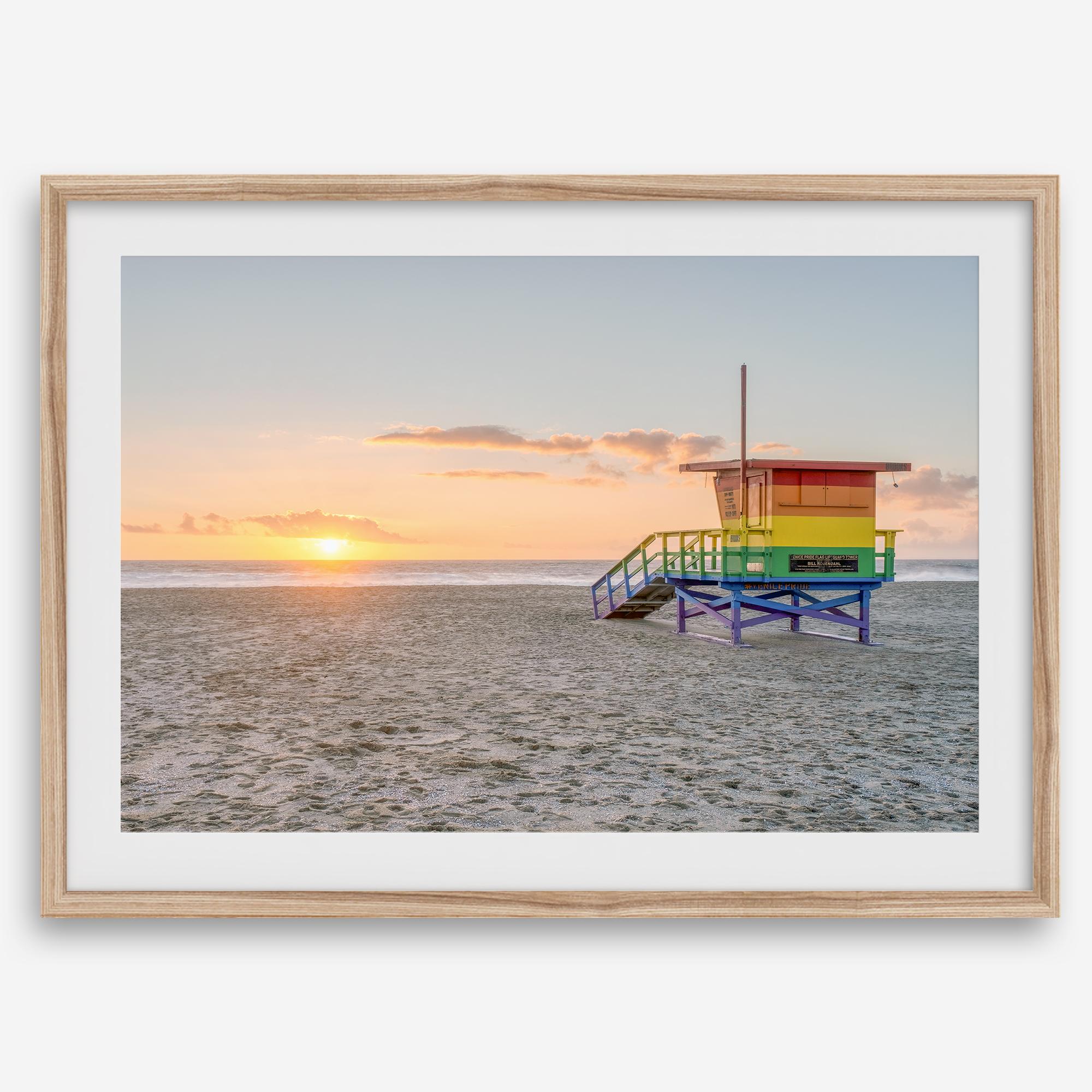 Venice Beach wall art featuring a colorful rainbow lifeguard tower beside the Pacific Ocean during a golden Los Angeles sunset.