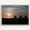 Step into Venice Beach with our fine art beach sunset framed or unframed print. The print showcases the beach in sunset with the silhouettes of the famous lifeguard towers and people in the sunset.