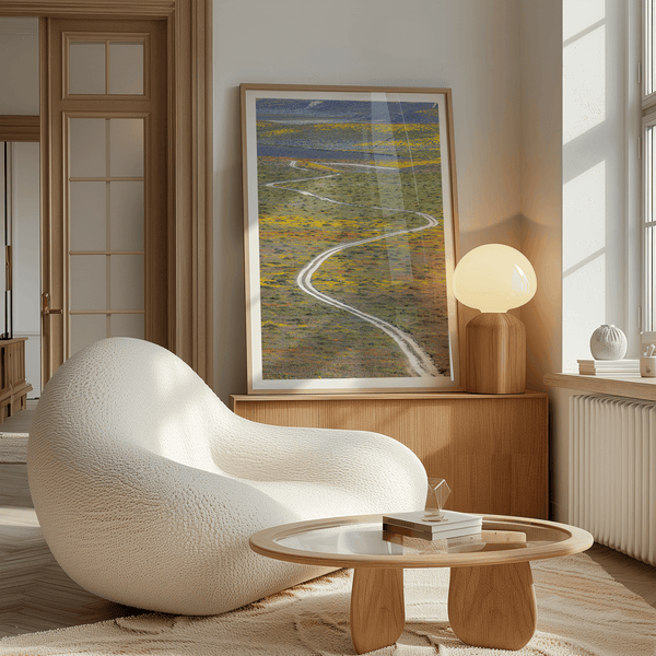 fine art photography print of a winding road disappearing into a valley filled with colorful wildflowers in Antelope Valley, California.