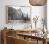 Black and white fine art print of Yosemite National Park in winter with snow-covered trees and granite cliffs.