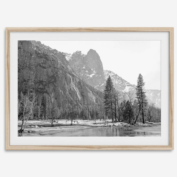 Black and white fine art print of Yosemite National Park in winter with snow-covered trees and granite cliffs.