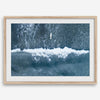 Aerial ocean wall art featuring a lone surfer and a breaking white wave in the deep blue waters of Hanalei Bay.