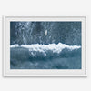 Aerial ocean wall art featuring a lone surfer and a breaking white wave in the deep blue waters of Hanalei Bay.