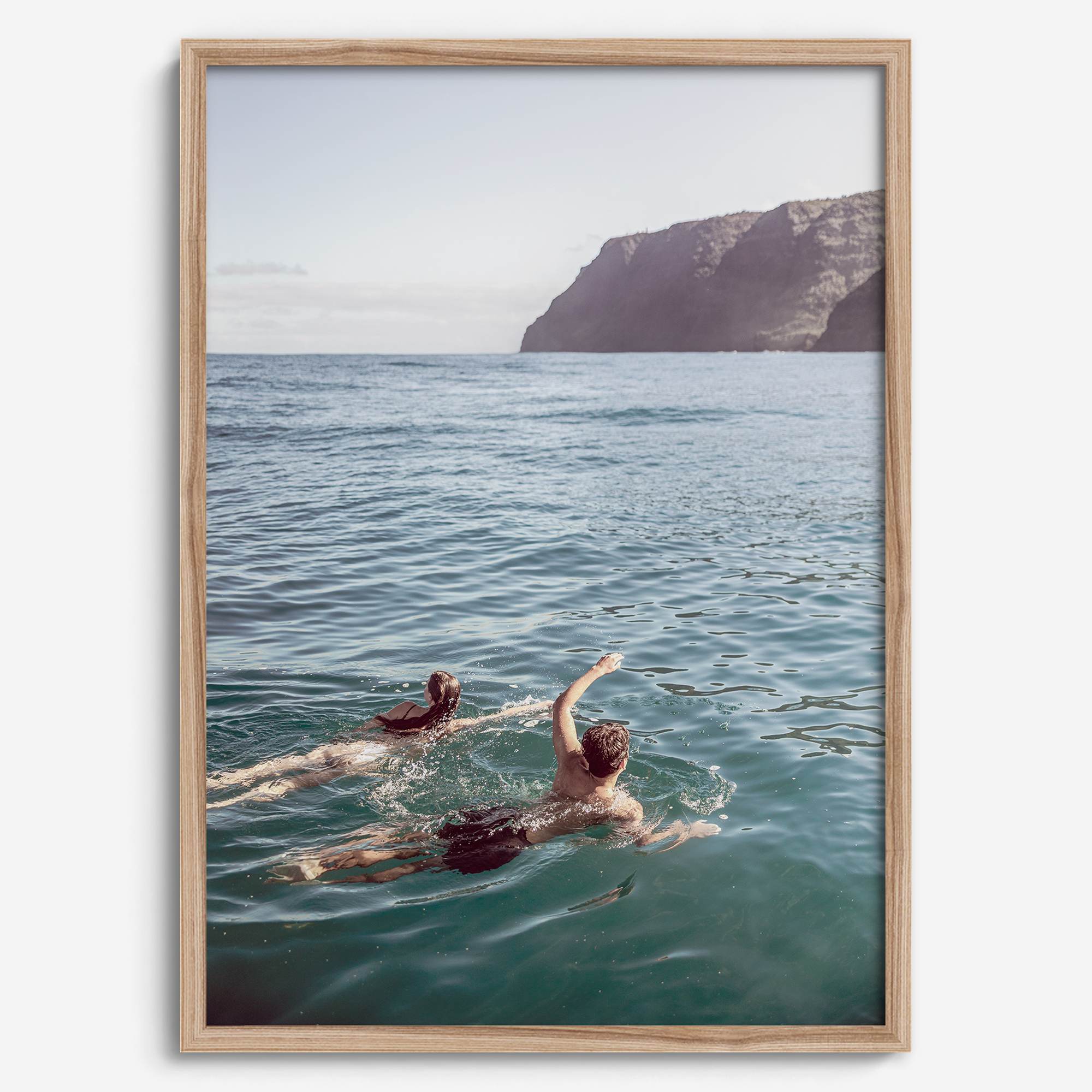 Summer wall art of a coastal Hawaiian landscape with figures swimming in deep blue ocean water.