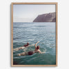 Summer wall art of a coastal Hawaiian landscape with figures swimming in deep blue ocean water.