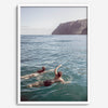 Summer wall art of a coastal Hawaiian landscape with figures swimming in deep blue ocean water.