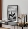 A black and white western rustic wall art - Cowgirl on horseback at sunset in desert landscape
