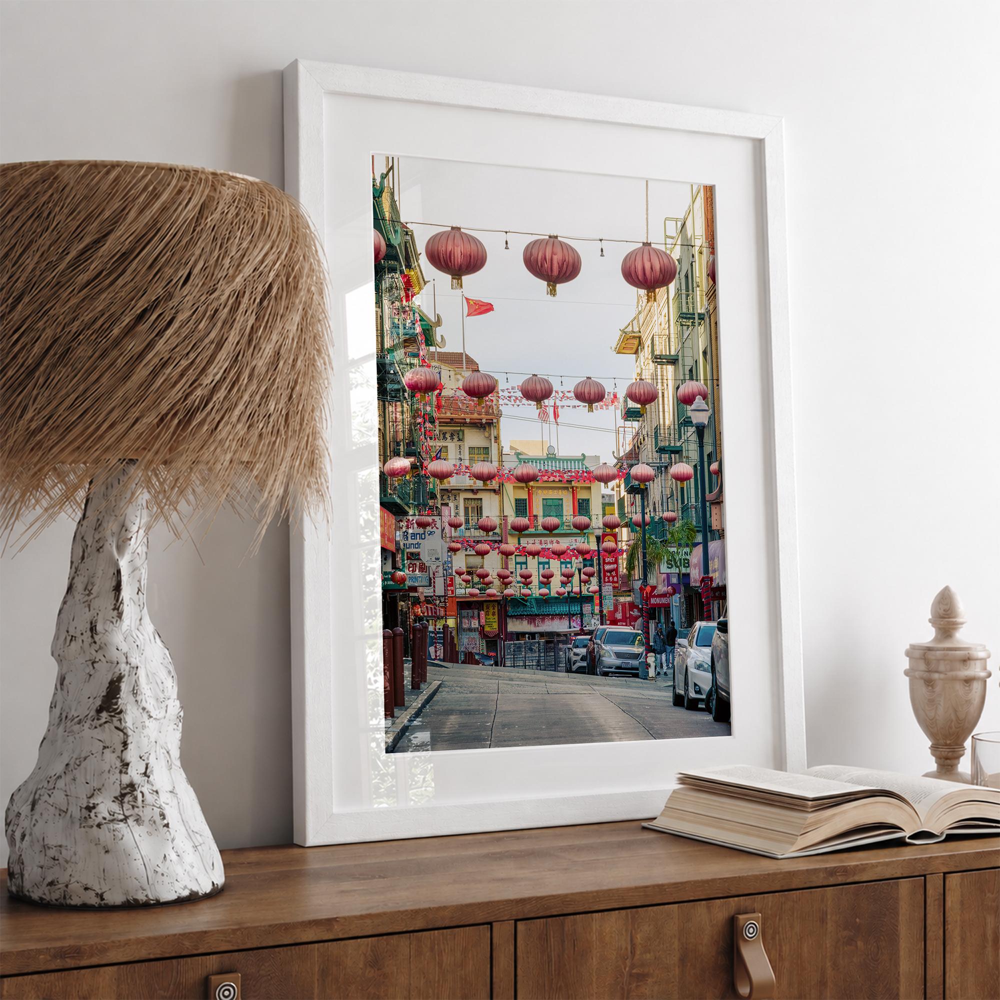 Chinatown Photography framed or unframed print showing red lanterns above a colorful San Francisco Chinatown street with shops and historic architecture.