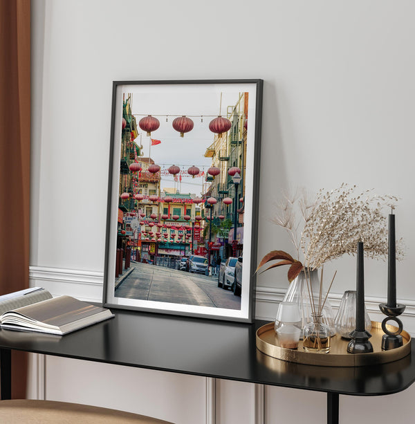 Chinatown Photography framed or unframed print showing red lanterns above a colorful San Francisco Chinatown street with shops and historic architecture.