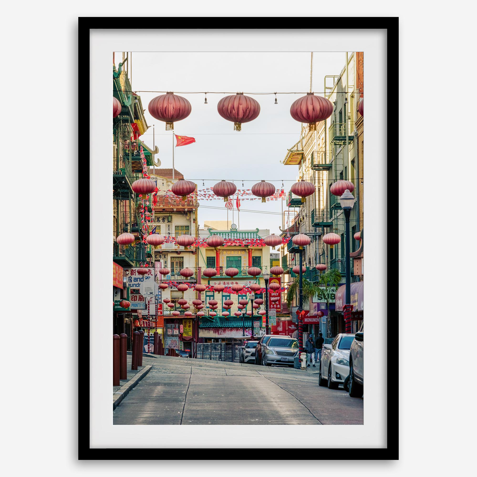 Chinatown Photography framed or unframed print showing red lanterns above a colorful San Francisco Chinatown street with shops and historic architecture.
