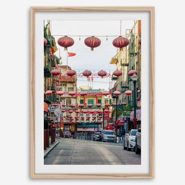 Chinatown Photography framed or unframed print showing red lanterns above a colorful San Francisco Chinatown street with shops and historic architecture.