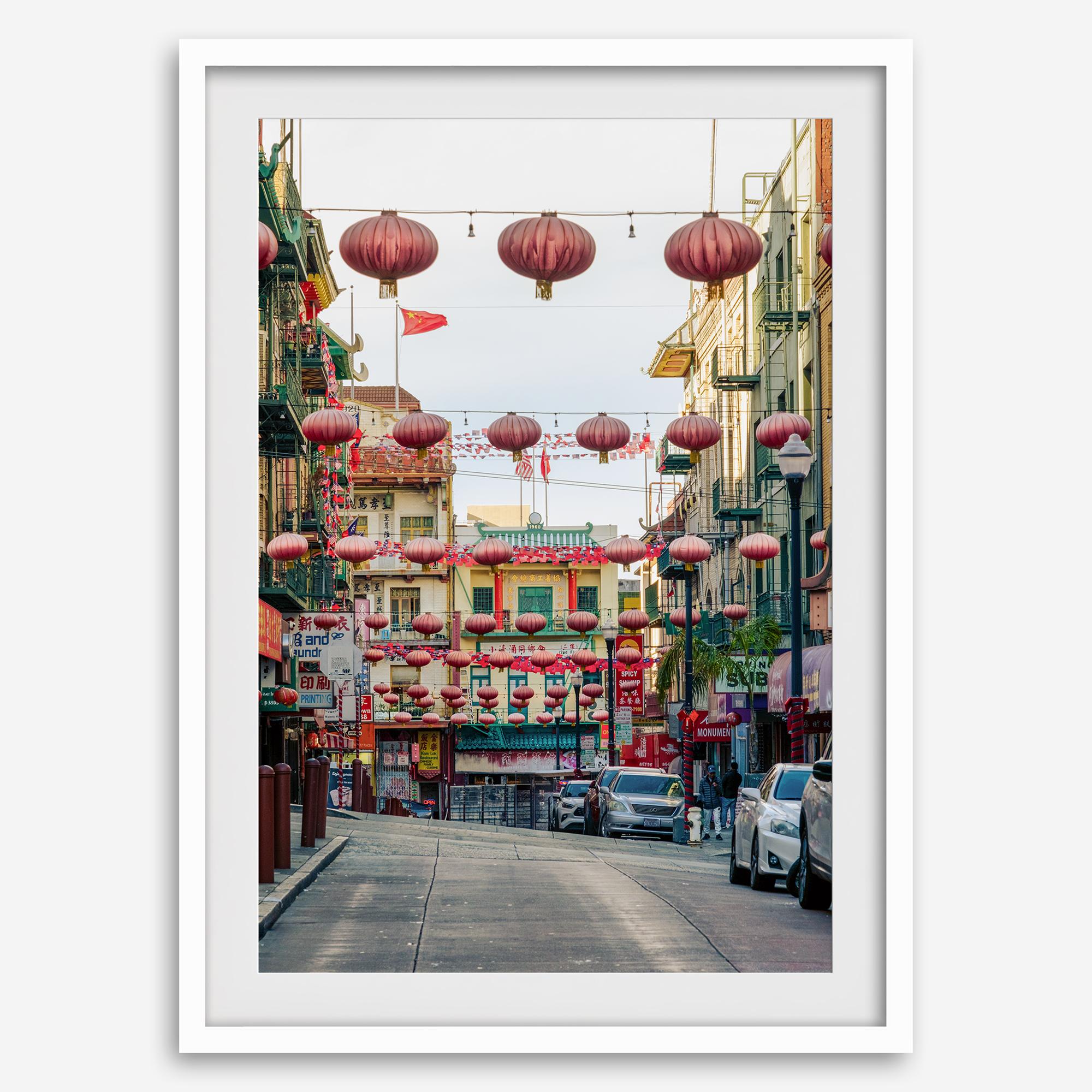 Chinatown Photography framed or unframed print showing red lanterns above a colorful San Francisco Chinatown street with shops and historic architecture.