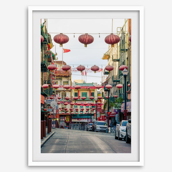Chinatown Photography framed or unframed print showing red lanterns above a colorful San Francisco Chinatown street with shops and historic architecture.