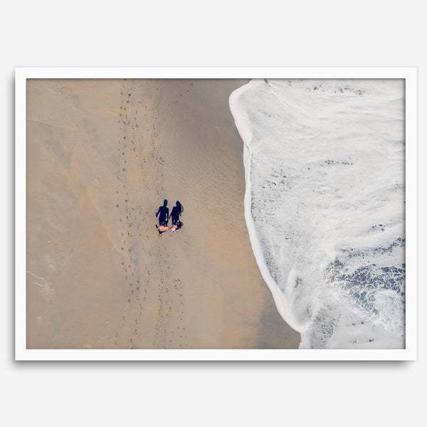Aerial beach photograph of a couple beside Pacific Ocean waves in Capitola, California, styled as romantic coastal bedroom wall art.