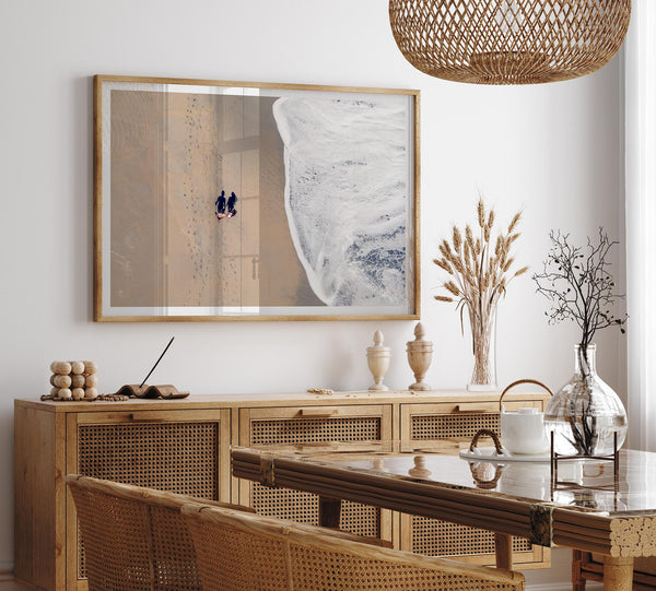 Aerial beach photograph of a couple beside Pacific Ocean waves in Capitola, California, styled as romantic coastal bedroom wall art.
