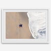 Aerial beach photograph of a couple beside Pacific Ocean waves in Capitola, California, styled as romantic coastal bedroom wall art.