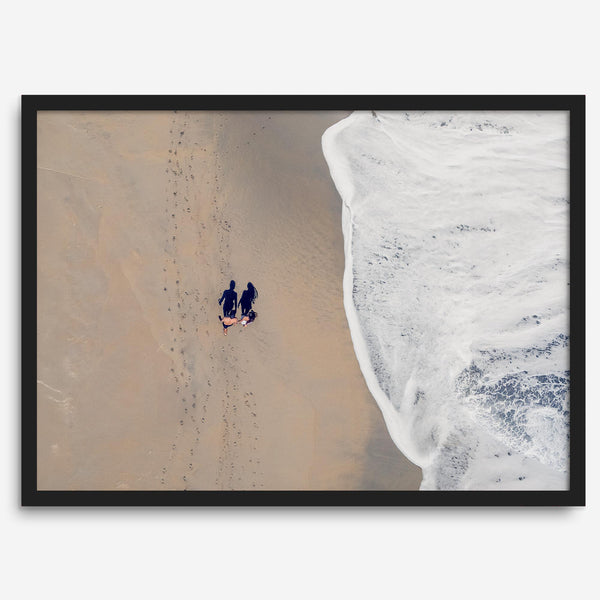 Aerial beach photograph of a couple beside Pacific Ocean waves in Capitola, California, styled as romantic coastal bedroom wall art.