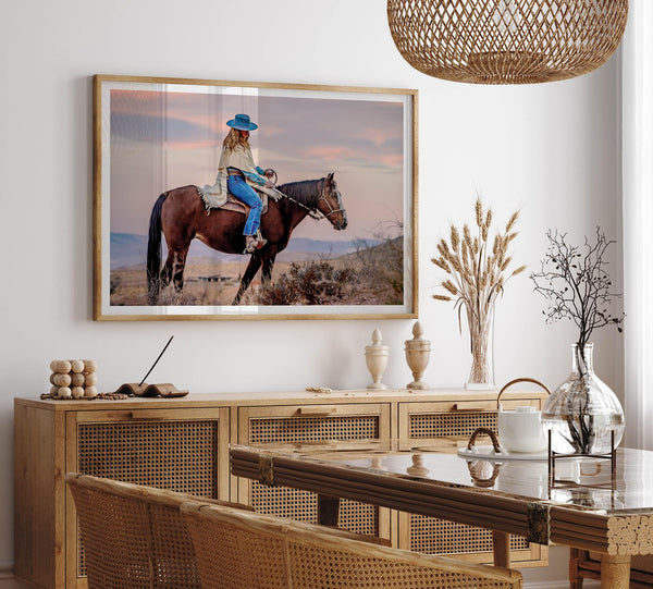 Cowgirl on horseback at sunset in desert landscape – rustic western wall decor print