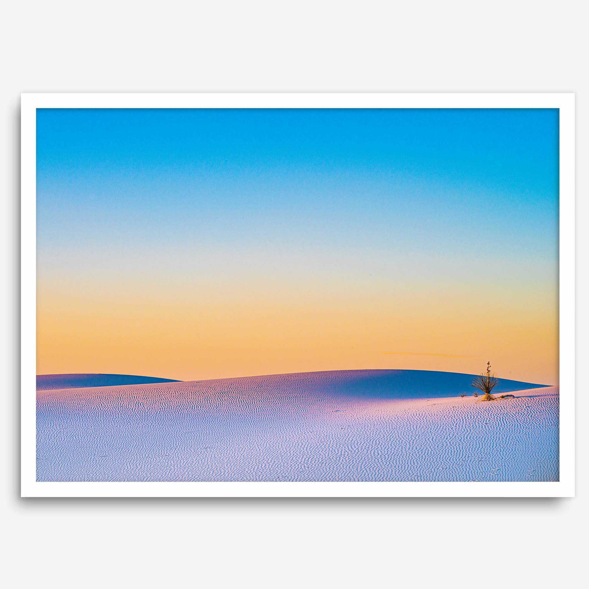 Panoramic desert landscape photography print showing White Sands National Park at sunset with blue sky and golden horizon.