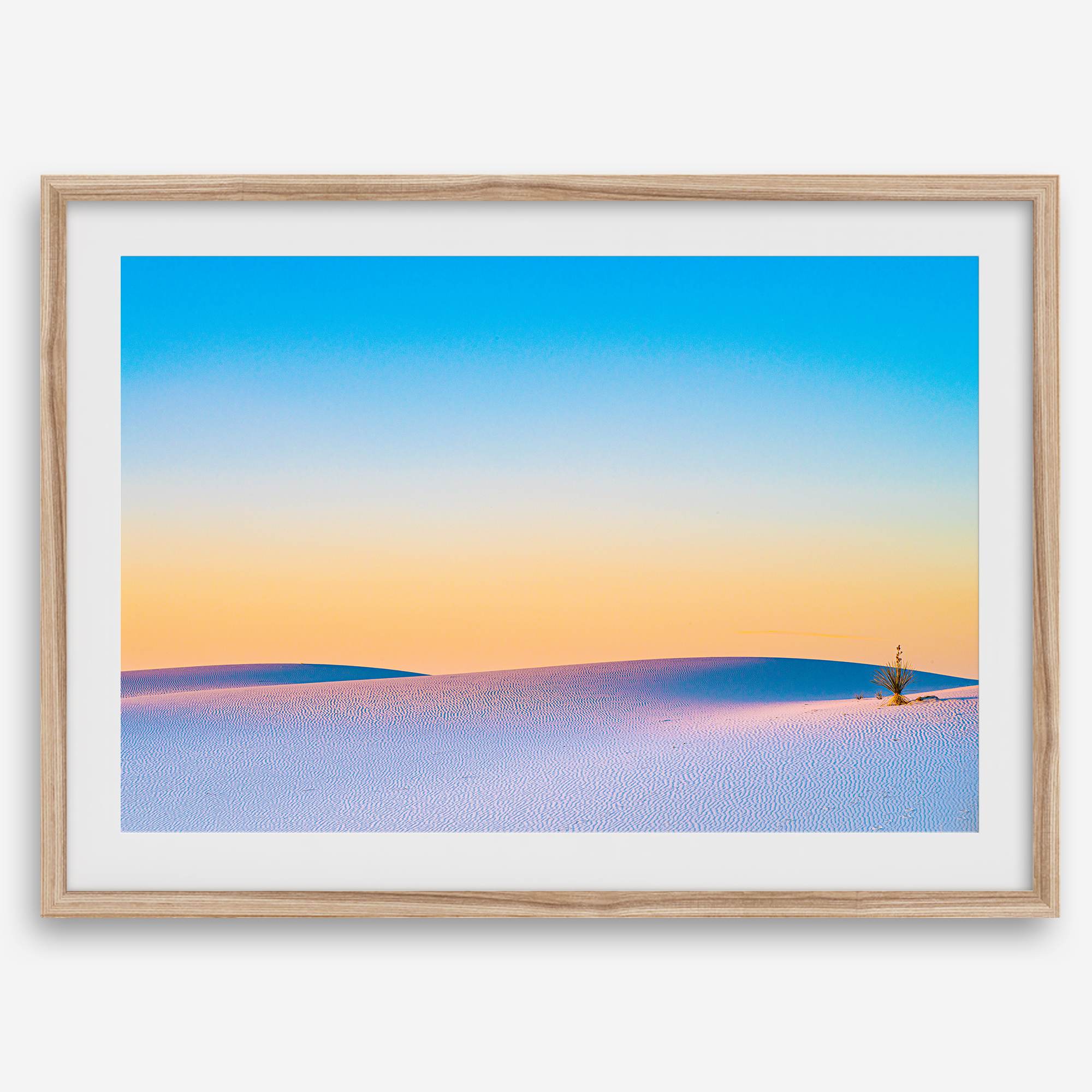 Panoramic desert landscape photography print showing White Sands National Park at sunset with blue sky and golden horizon.