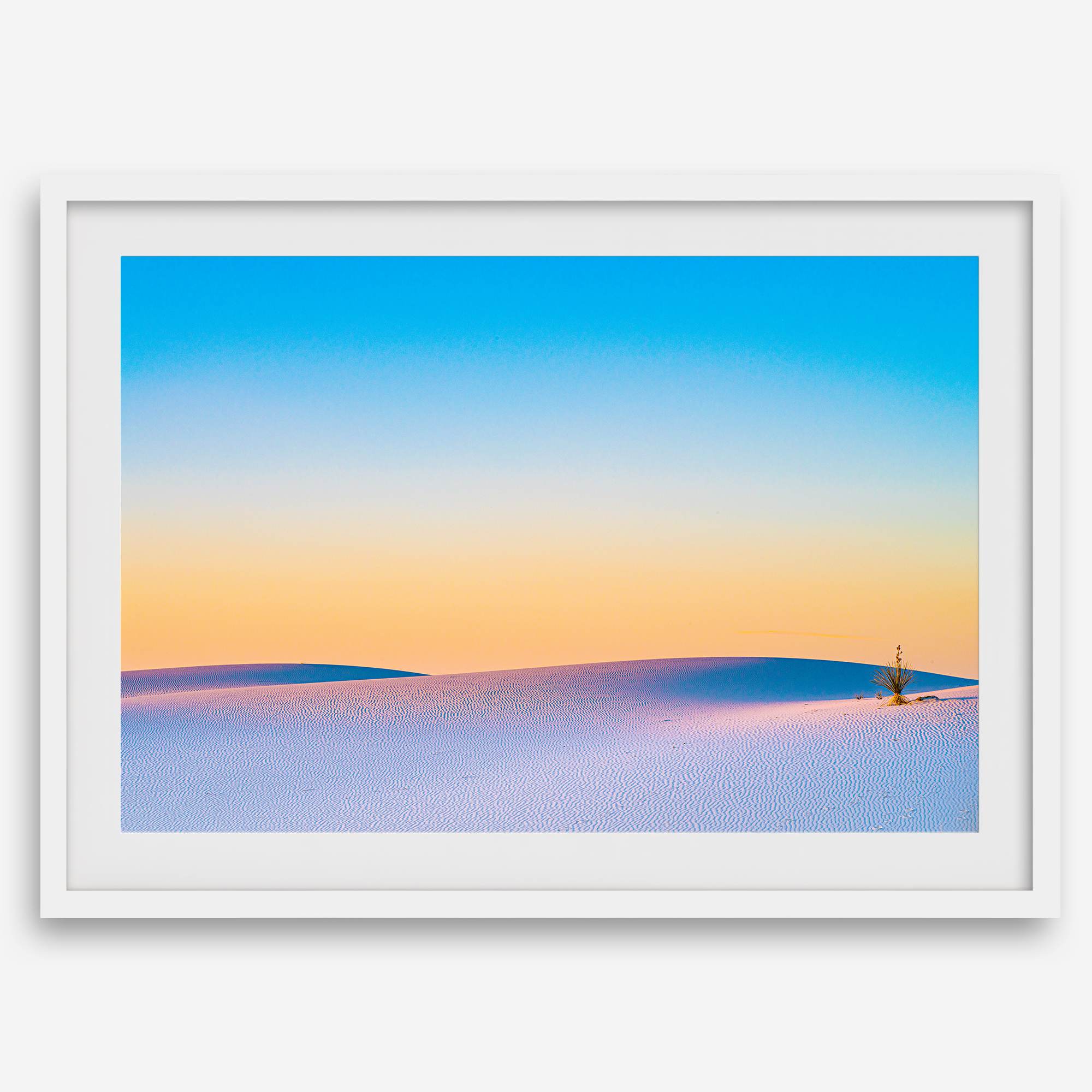 Panoramic desert landscape photography print showing White Sands National Park at sunset with blue sky and golden horizon.