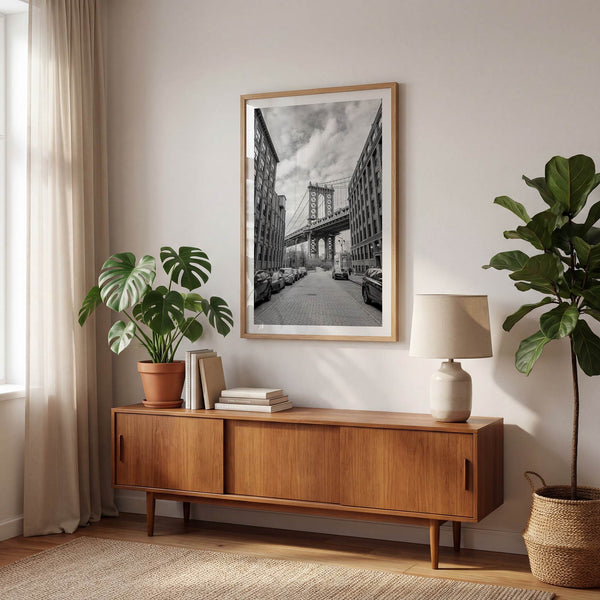 Framed Manhattan Bridge photography print in Dumbo Brooklyn with cobblestone street and monochrome architecture