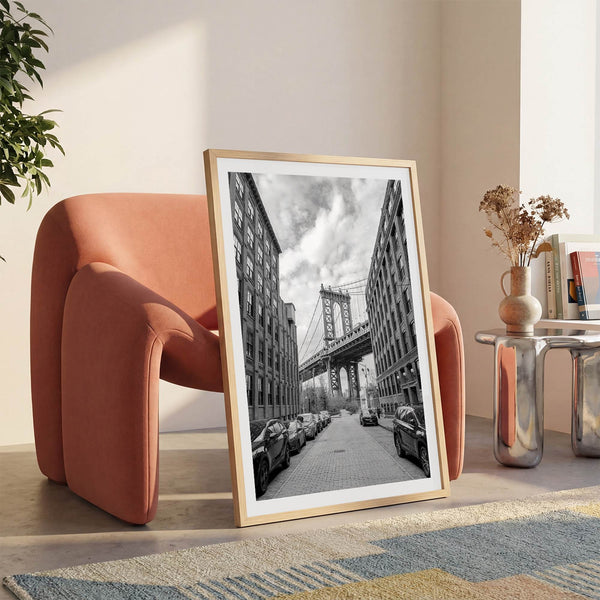 Framed Manhattan Bridge photography print in Dumbo Brooklyn with cobblestone street and monochrome architecture