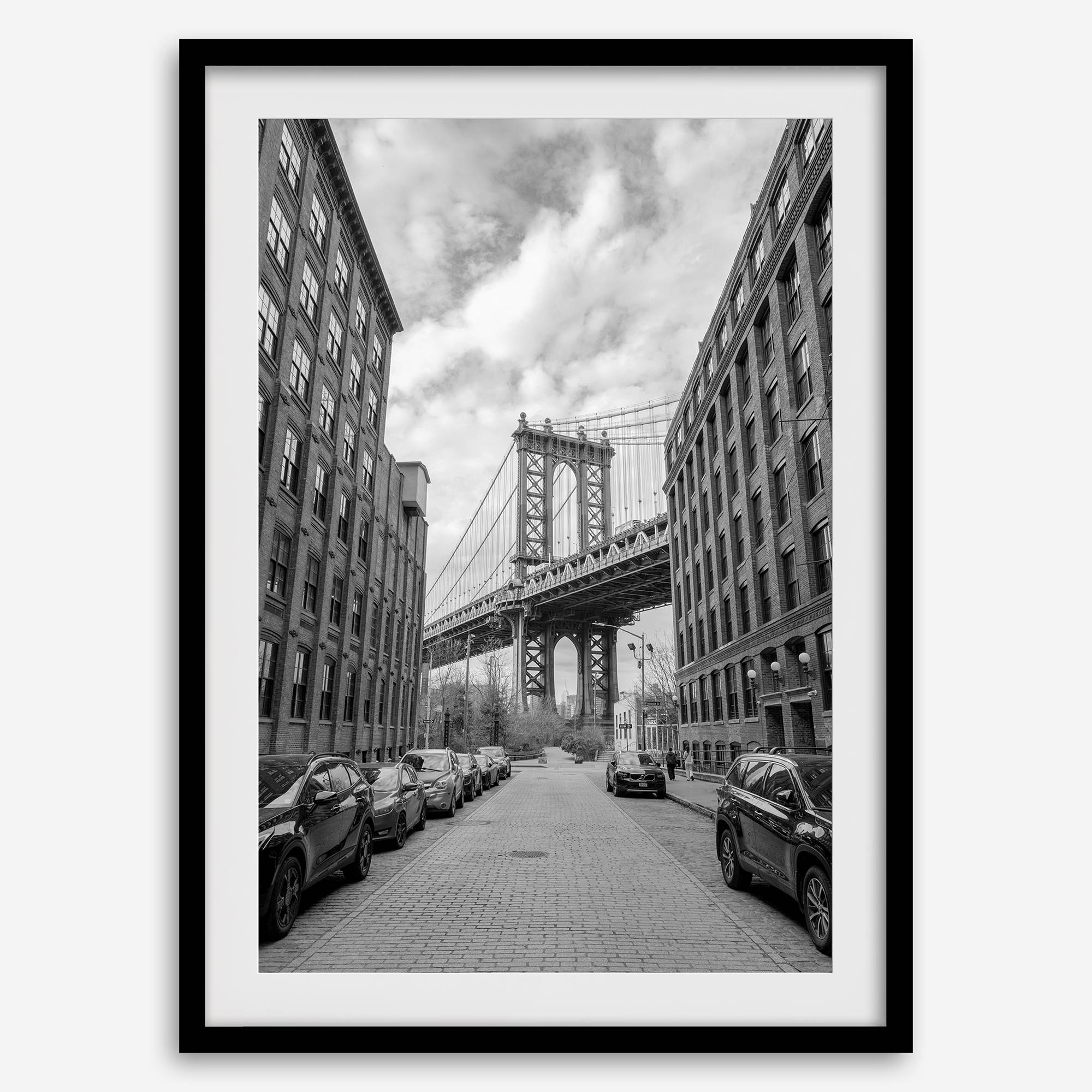 Framed Manhattan Bridge photography print in Dumbo Brooklyn with cobblestone street and monochrome architecture