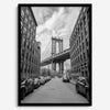 Framed Manhattan Bridge photography print in Dumbo Brooklyn with cobblestone street and monochrome architecture