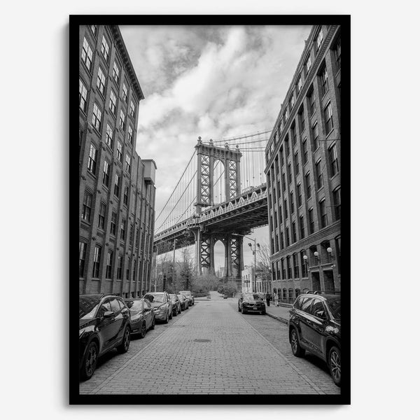Framed Manhattan Bridge photography print in Dumbo Brooklyn with cobblestone street and monochrome architecture