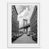 Framed Manhattan Bridge photography print in Dumbo Brooklyn with cobblestone street and monochrome architecture