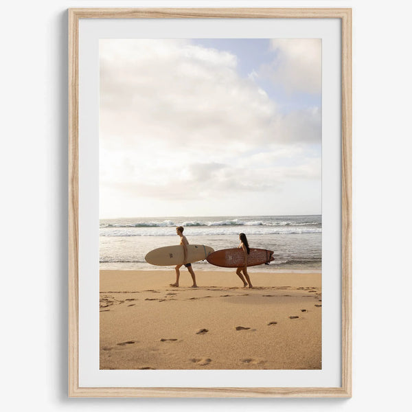 Framed surfers on beach art print featuring Hawaiian coastline and calm morning tones