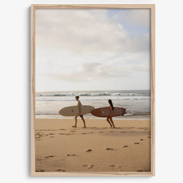 Framed surfers on beach art print featuring Hawaiian coastline and calm morning tones