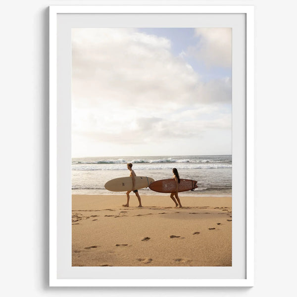 Framed surfers on beach art print featuring Hawaiian coastline and calm morning tones