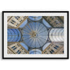 Framed fine art print featuring a symmetrical view of the glass and steel roof of the Galleria Umberto I, a historic building in Naples, Italy. The intricate geometric patterns create an abstract composition.