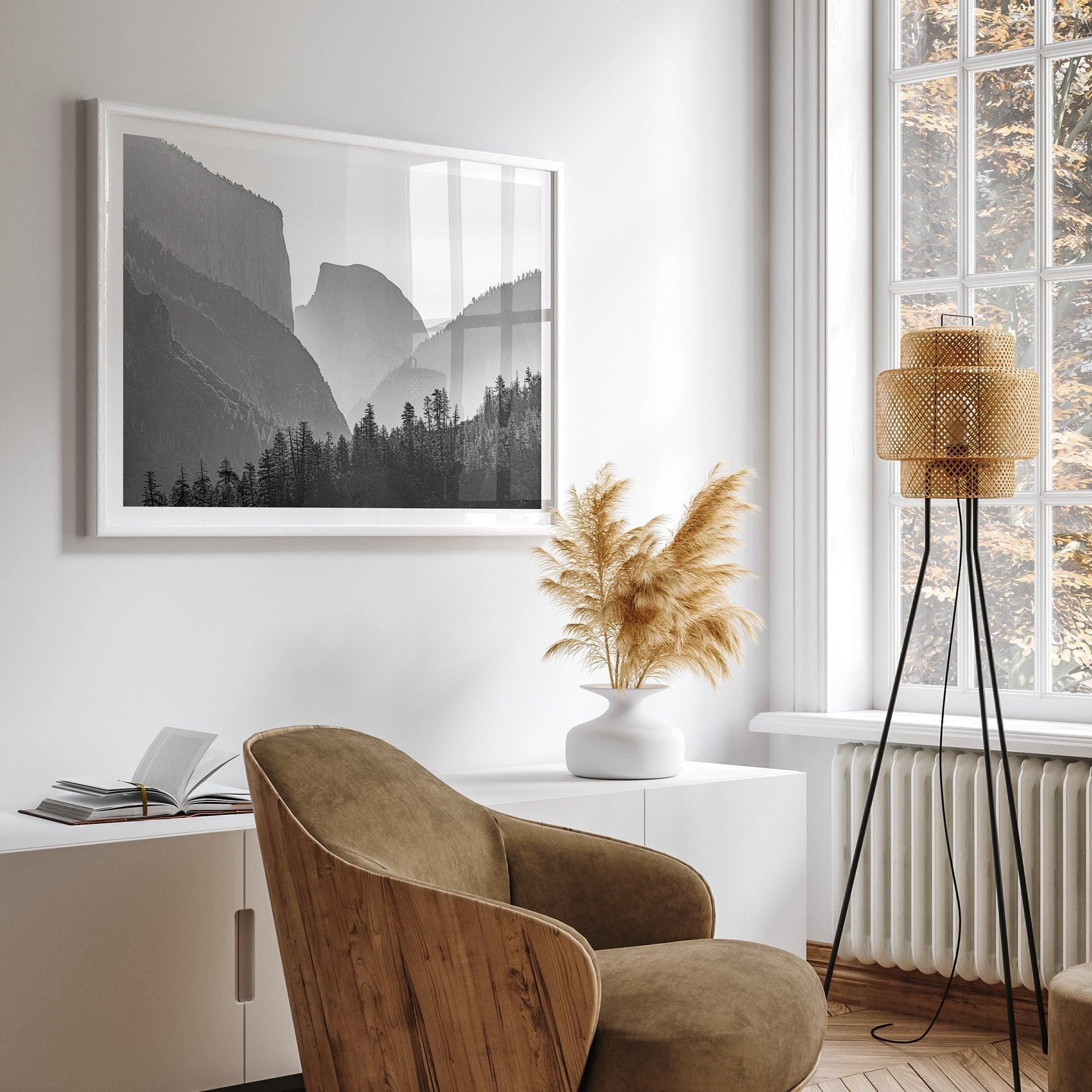 A black and white photography wall art of Yosemite Valley at sunset, featuring the iconic Half Dome and El Capitan bathed in dramatic light and shadow. Perfect for nature lovers and art enthusiasts.
