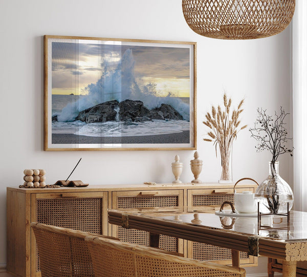 A dramatic fine art beach print showing a huge ocean wave crashing on a beautiful beach in California during sunset