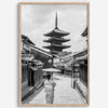 Timeless Kyoto scene with traditional architecture and kimono-clad woman in black and white.