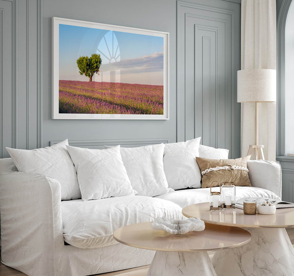 Fine art photograph of a heart shaped tree surrounded by lavender fields in Provence, France beneath a soft blue sky.
