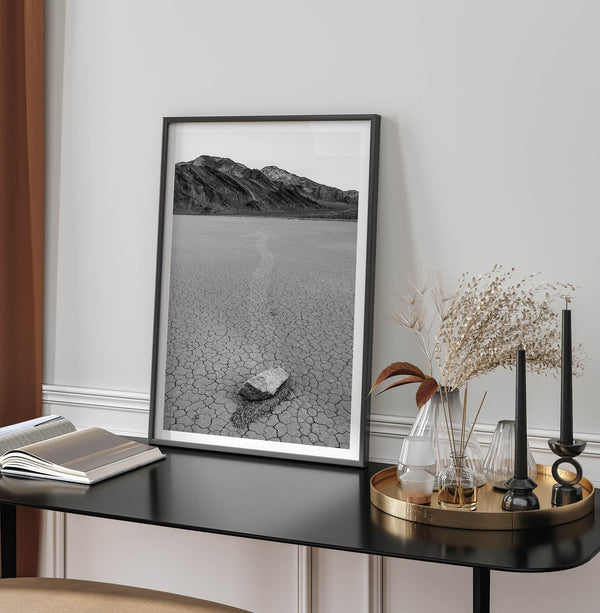 Fine art mojave print showing a sailing stone on Racetrack Playa in Death Valley with mountains in the background.