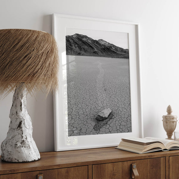 Fine art mojave print showing a sailing stone on Racetrack Playa in Death Valley with mountains in the background.