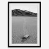 Fine art mojave print showing a sailing stone on Racetrack Playa in Death Valley with mountains in the background.