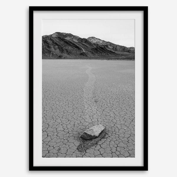 Fine art mojave print showing a sailing stone on Racetrack Playa in Death Valley with mountains in the background.