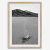 Fine art mojave print showing a sailing stone on Racetrack Playa in Death Valley with mountains in the background.