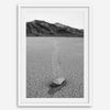 Fine art mojave print showing a sailing stone on Racetrack Playa in Death Valley with mountains in the background.