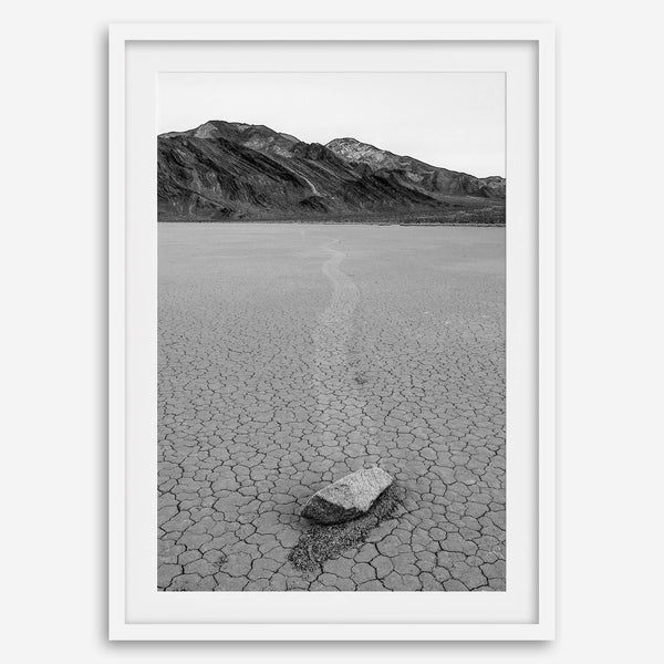 Fine art mojave print showing a sailing stone on Racetrack Playa in Death Valley with mountains in the background.