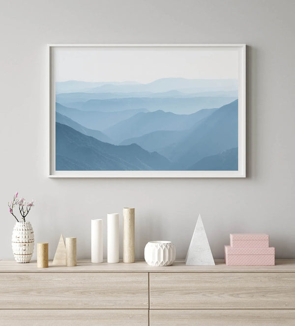 A fine art mountain photography print showing tens of shaded mountains one after the other. This minimalist mountain range wall art is perfect for nature lovers.