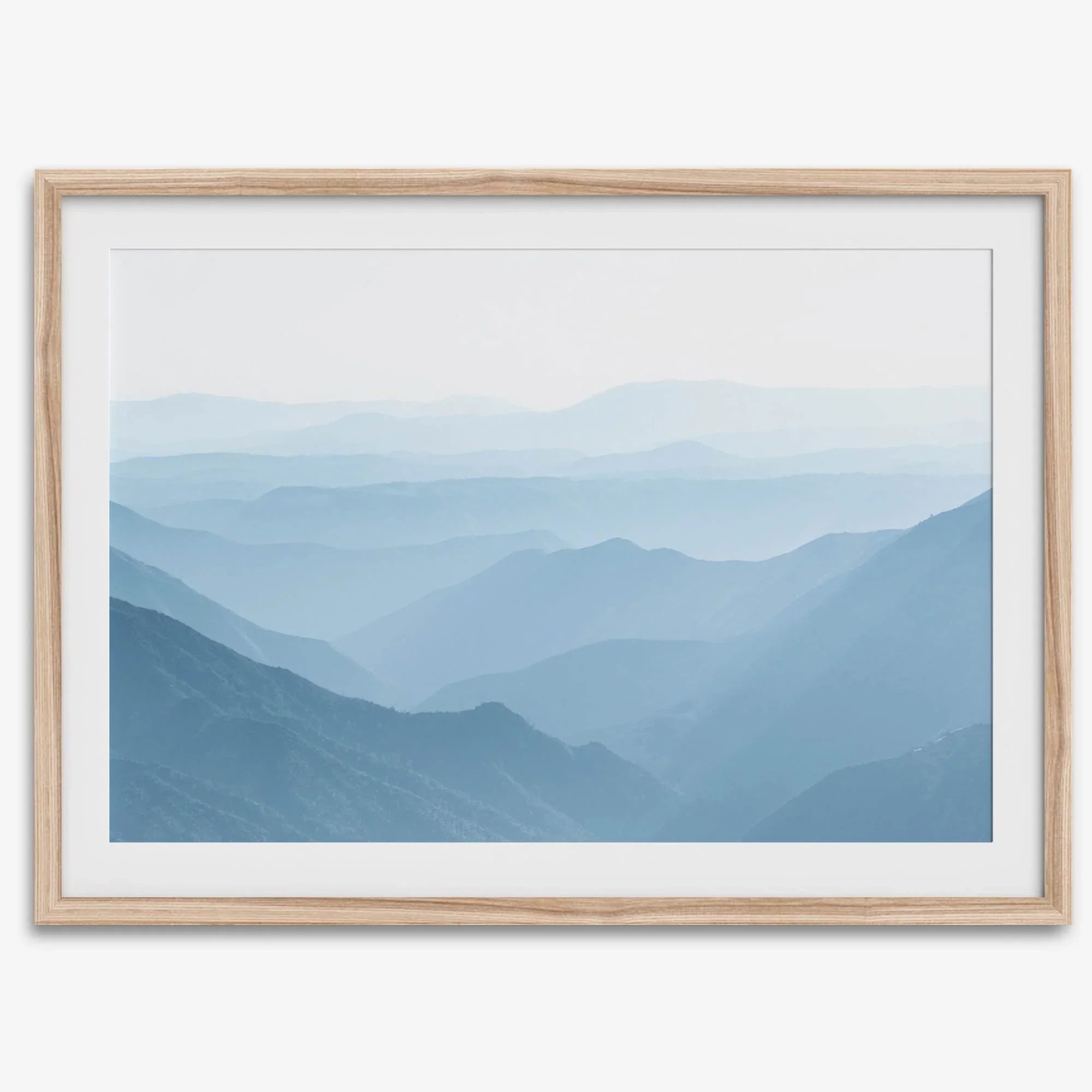 A fine art mountain photography print showing tens of shaded mountains one after the other. This minimalist mountain range wall art is perfect for nature lovers.