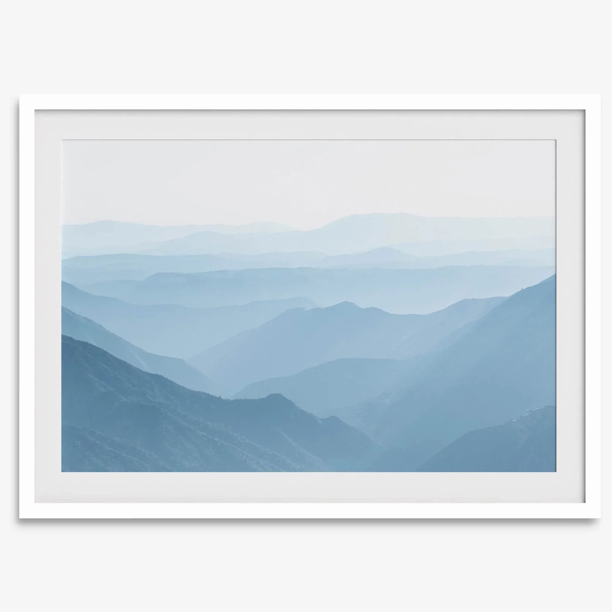 A fine art mountain photography print showing tens of shaded mountains one after the other. This minimalist mountain range wall art is perfect for nature lovers.