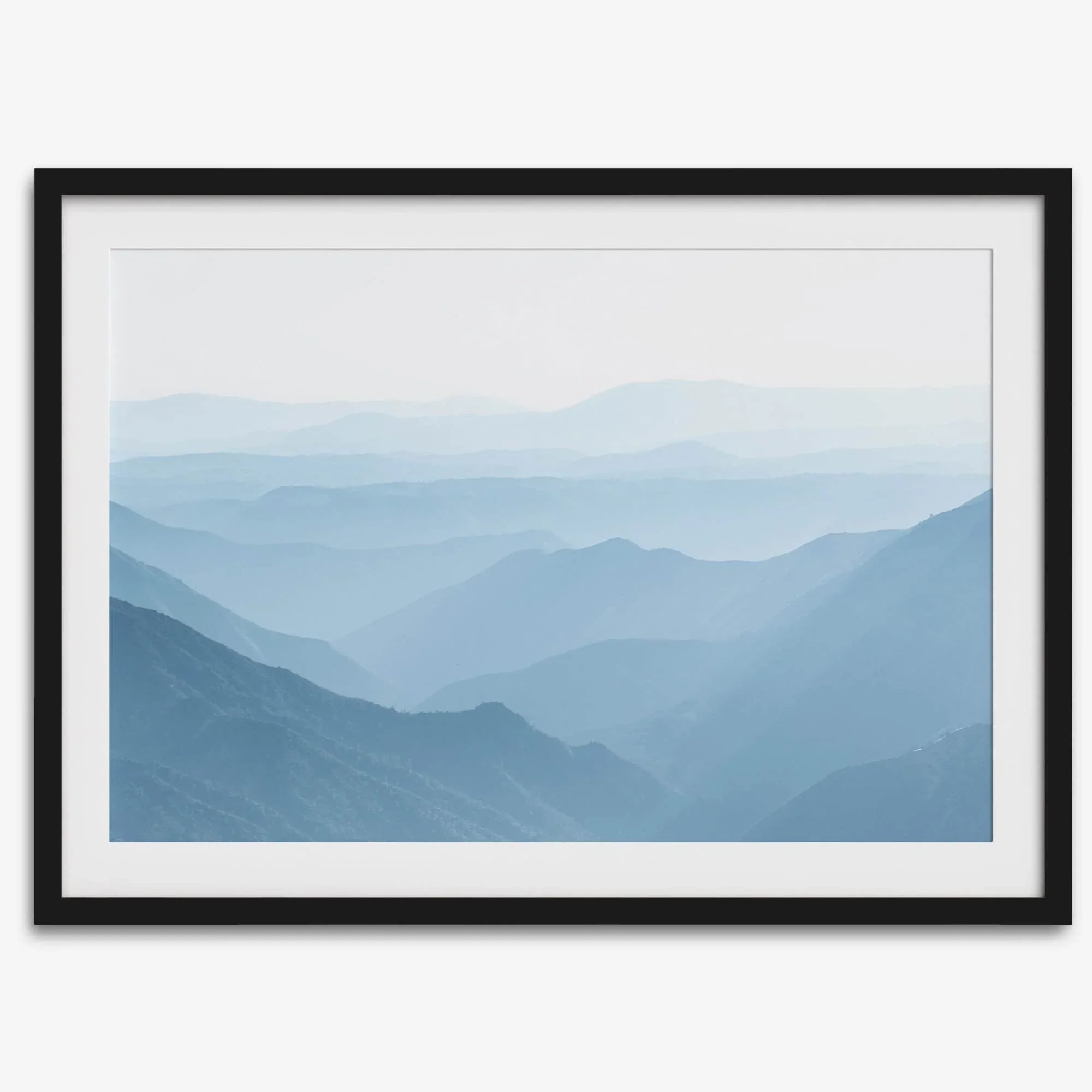 A fine art mountain photography print showing tens of shaded mountains one after the other. This minimalist mountain range wall art is perfect for nature lovers.